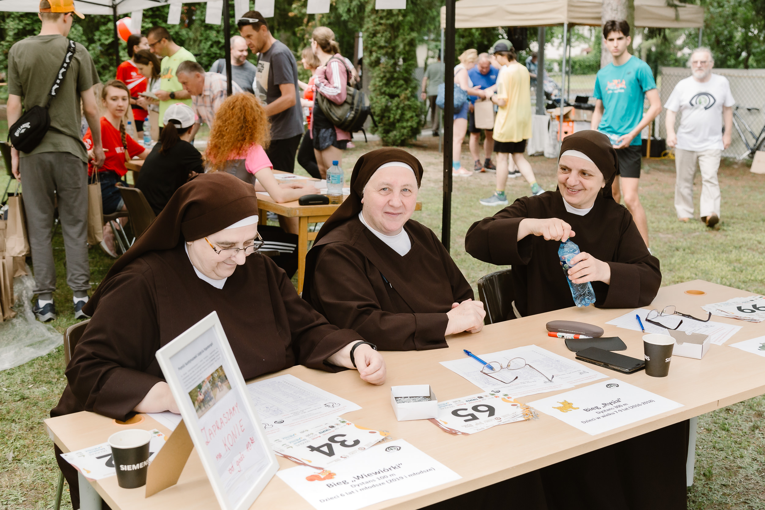 Trzy franciszkanki obsługują biuro zawodów.
